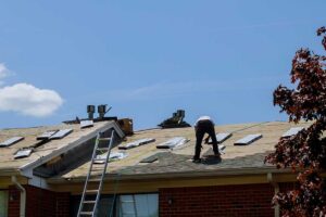 Vented soffits and painted fascia beneath a residential roof eave with attached gutters